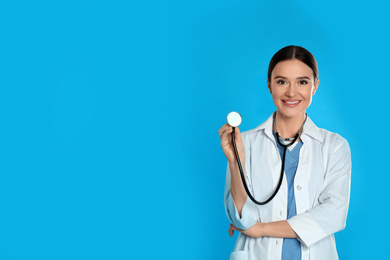 Photo of Doctor with stethoscope on blue background. Space for text