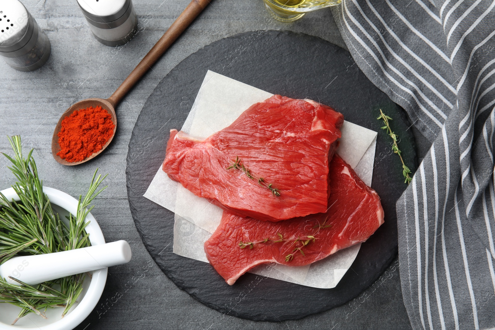 Photo of Flat lay composition with fresh beef cut on grey table