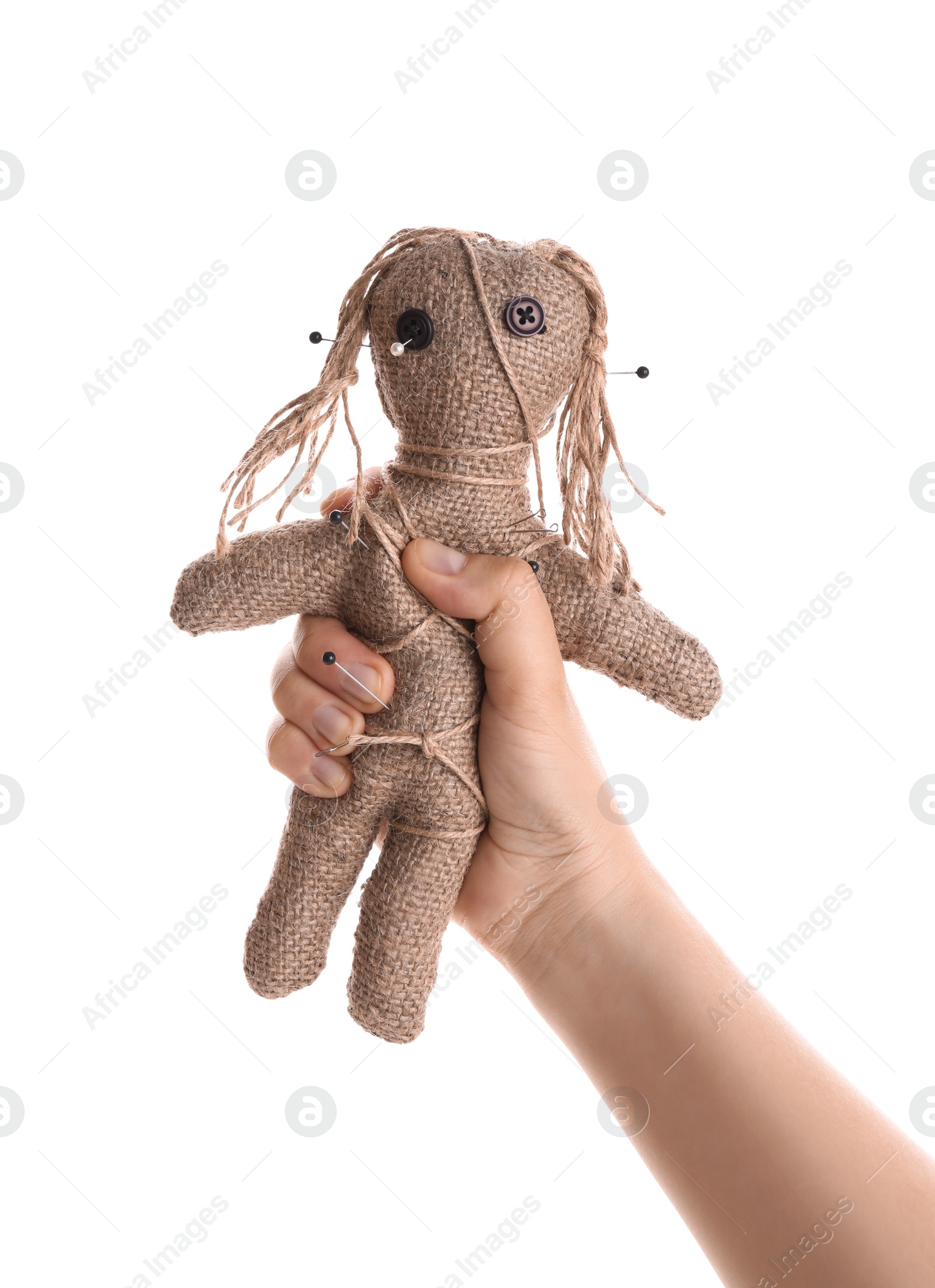 Photo of Woman holding voodoo doll with pins on white background, closeup. Curse ceremony