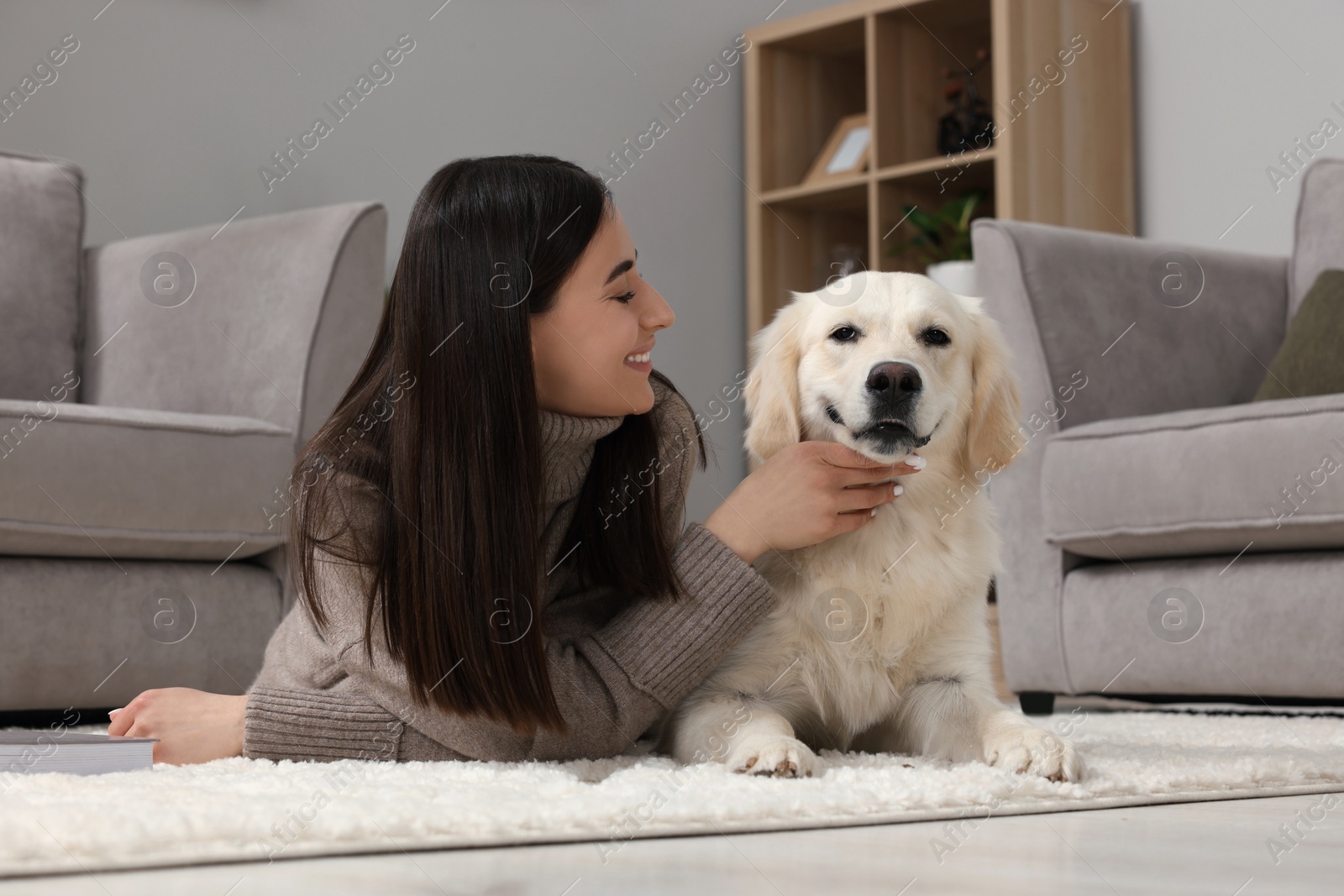 Photo of Happy woman with cute Labrador Retriever dog on floor at home. Adorable pet