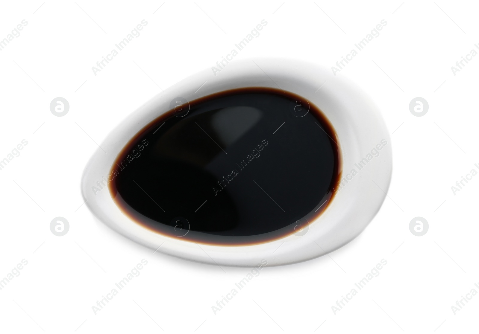 Photo of Dish of soy sauce on white background, top view