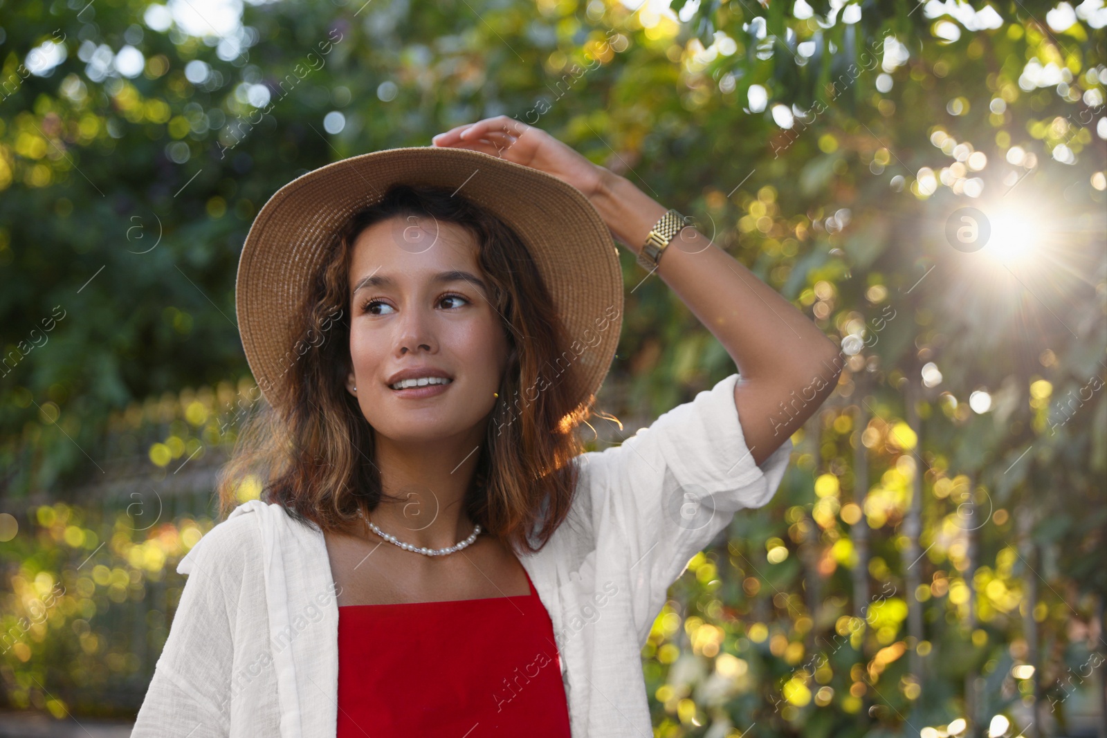 Photo of Portrait of happy young woman in straw hat outdoors on sunny day