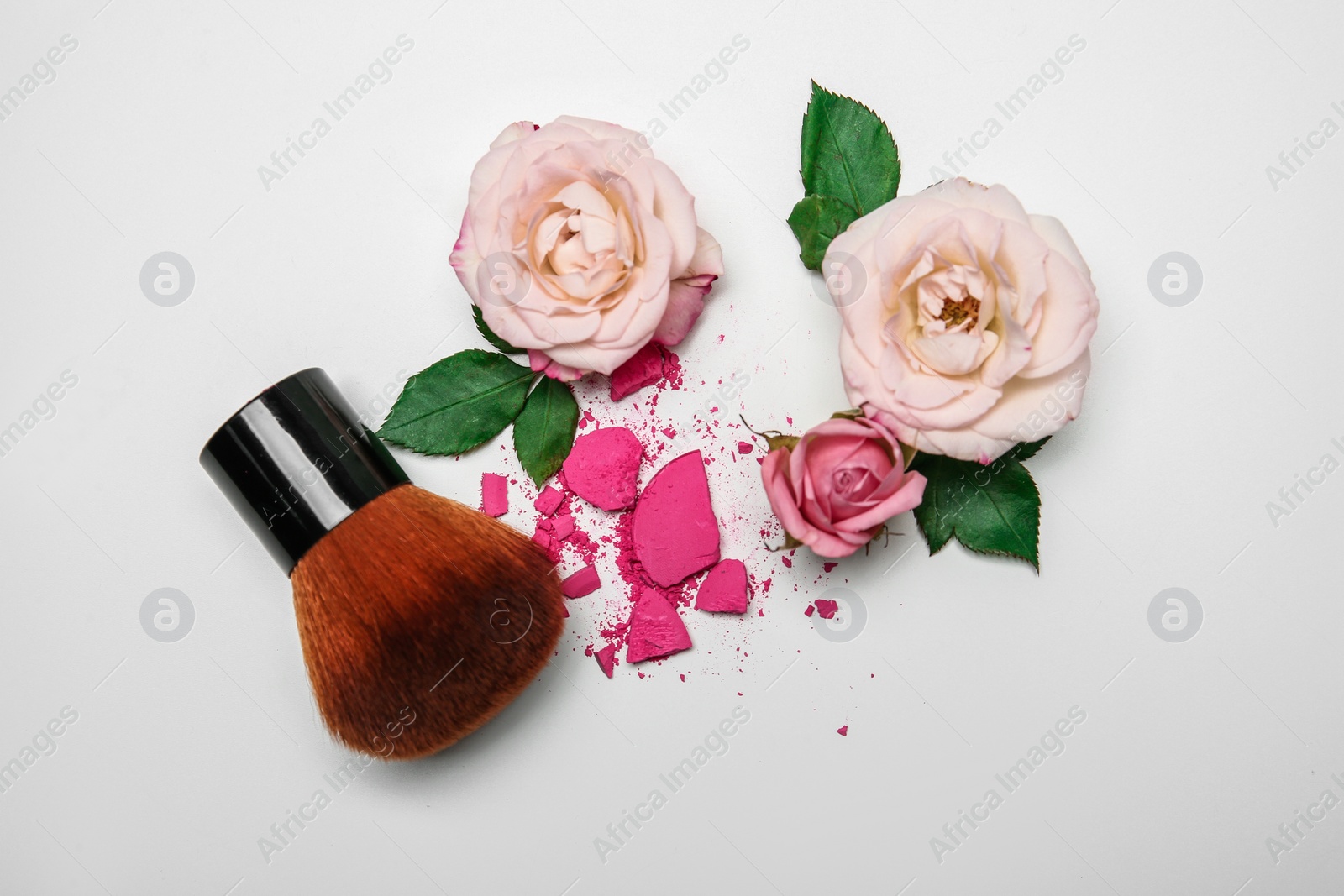 Photo of Flat lay composition with makeup brush and flowers on white background