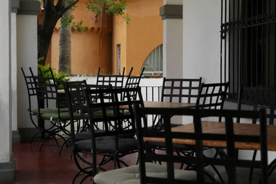 Photo of Chairs at tables on terrace near cafe