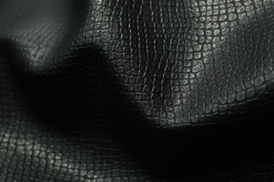 Black natural leather as background, closeup view