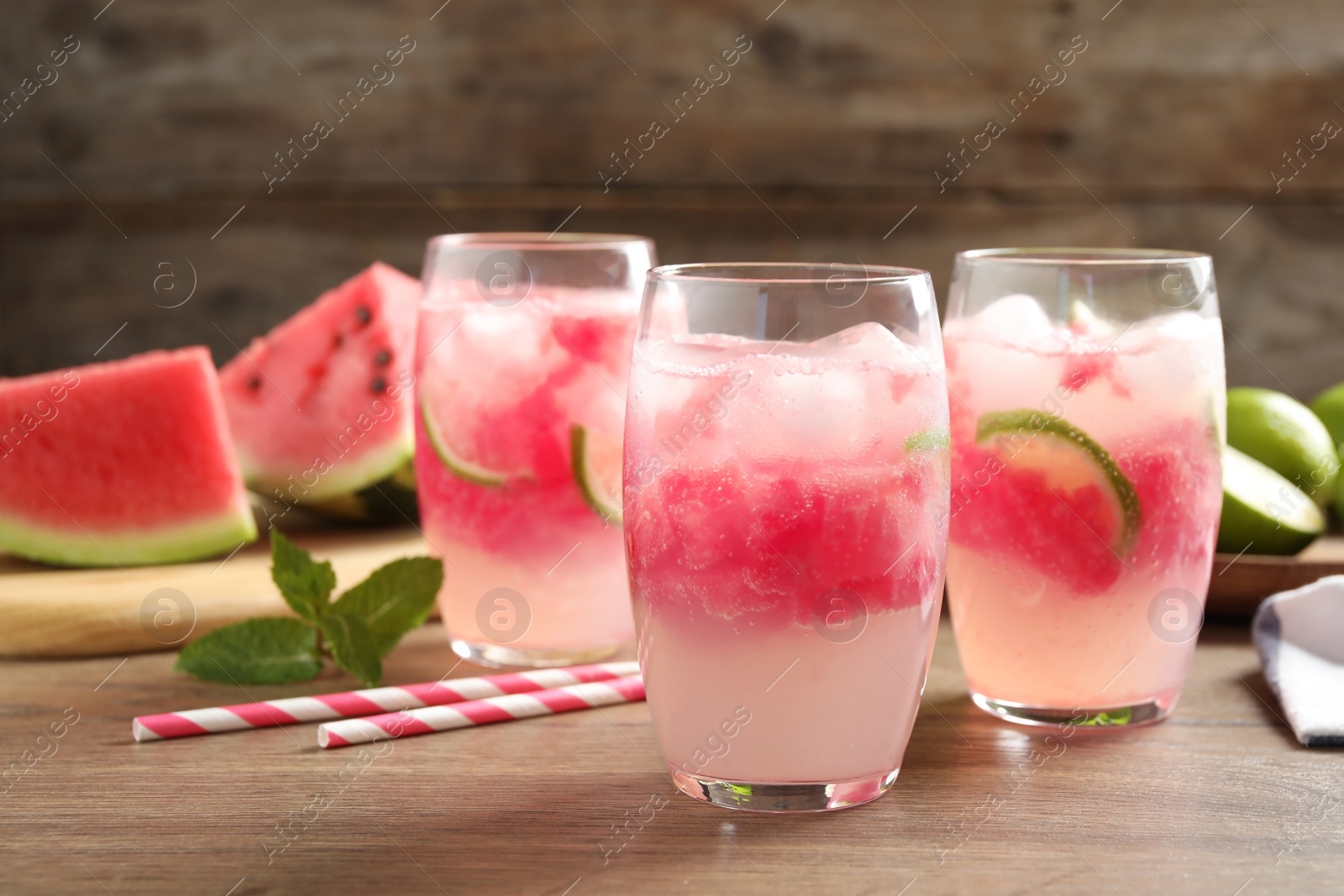 Photo of Delicious refreshing watermelon drink on wooden table