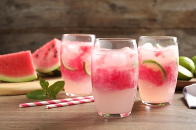 Photo of Delicious refreshing watermelon drink on wooden table