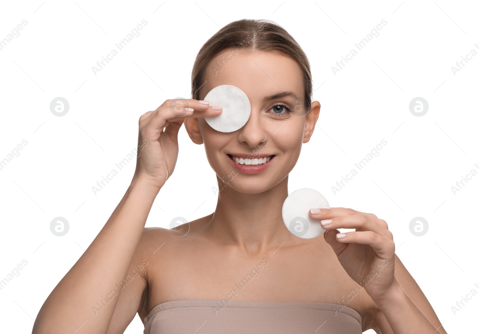 Photo of Smiling woman removing makeup with cotton pads on white background