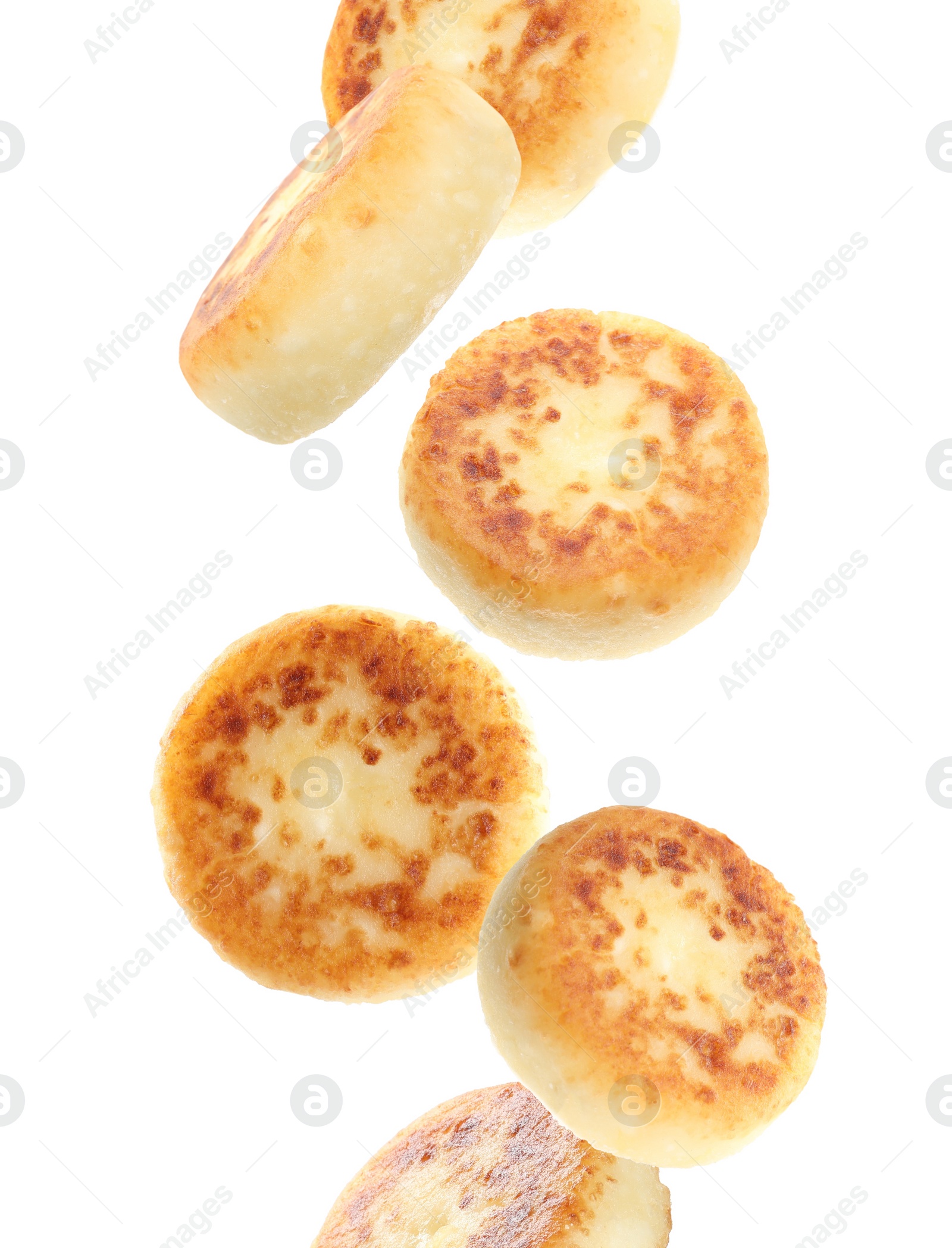 Image of Delicious cottage cheese pancakes falling on white background