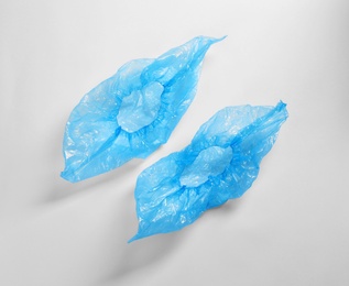 Photo of Medical blue shoe covers on white background