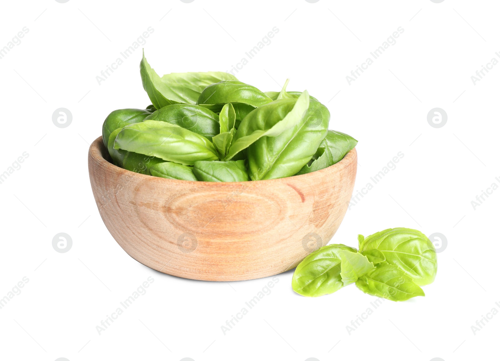 Photo of Fresh green basil leaves in wooden bowl isolated on white