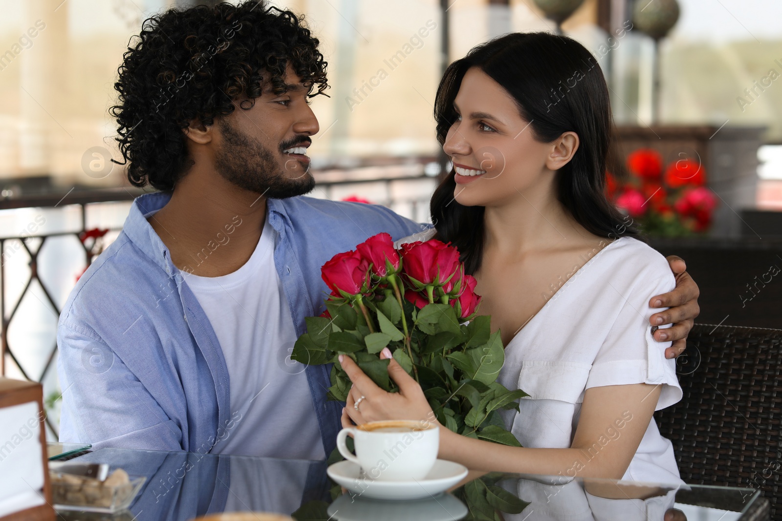 Photo of International dating. Happy couple spending time together in restaurant