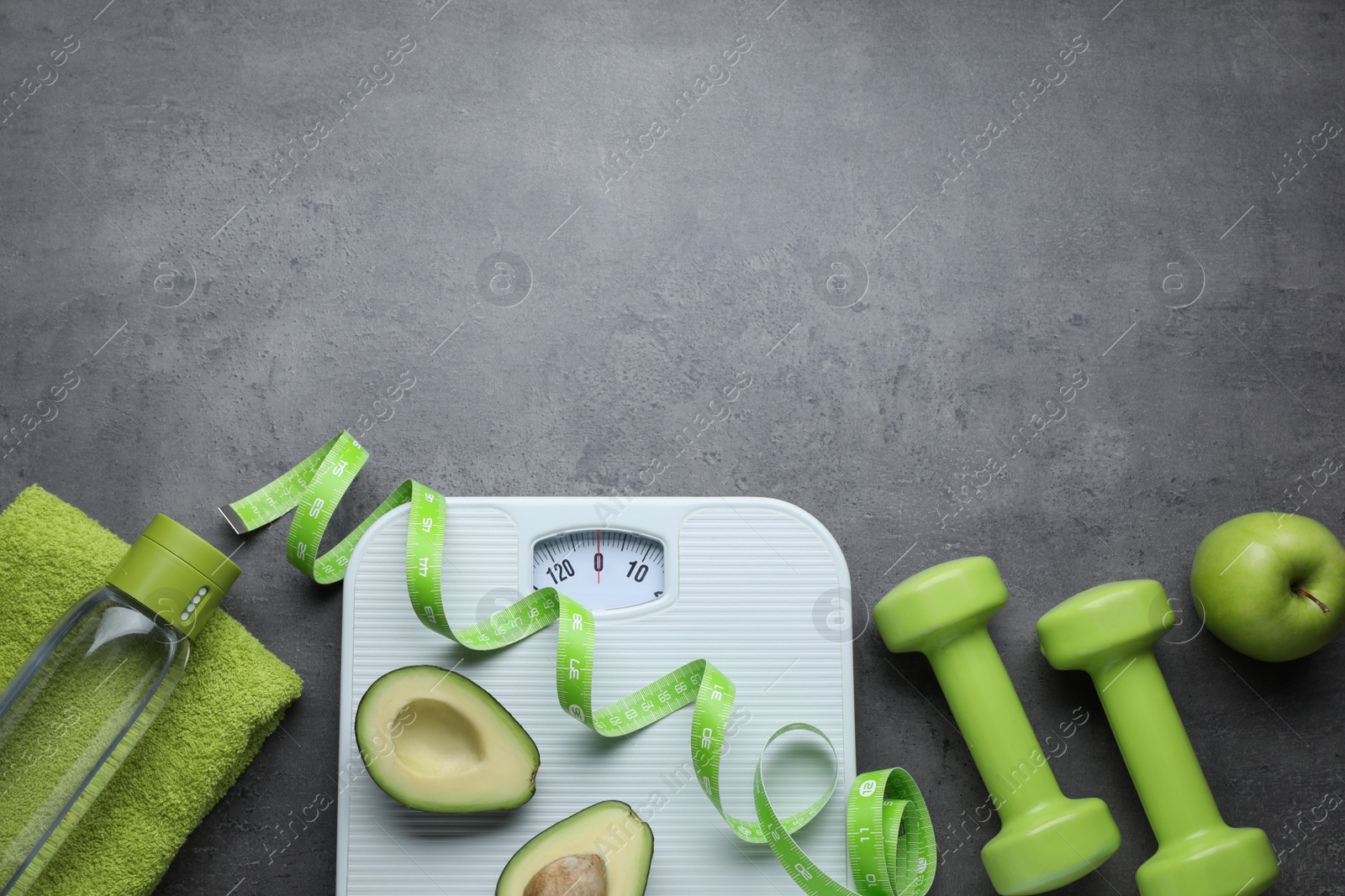 Photo of Flat lay composition with scales and measuring tape on grey background, space for text