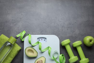 Photo of Flat lay composition with scales and measuring tape on grey background, space for text