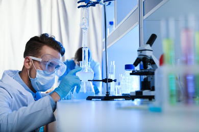 Young scientist doing research and analysis in chemical laboratory