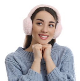 Photo of Beautiful young woman wearing earmuffs on white background