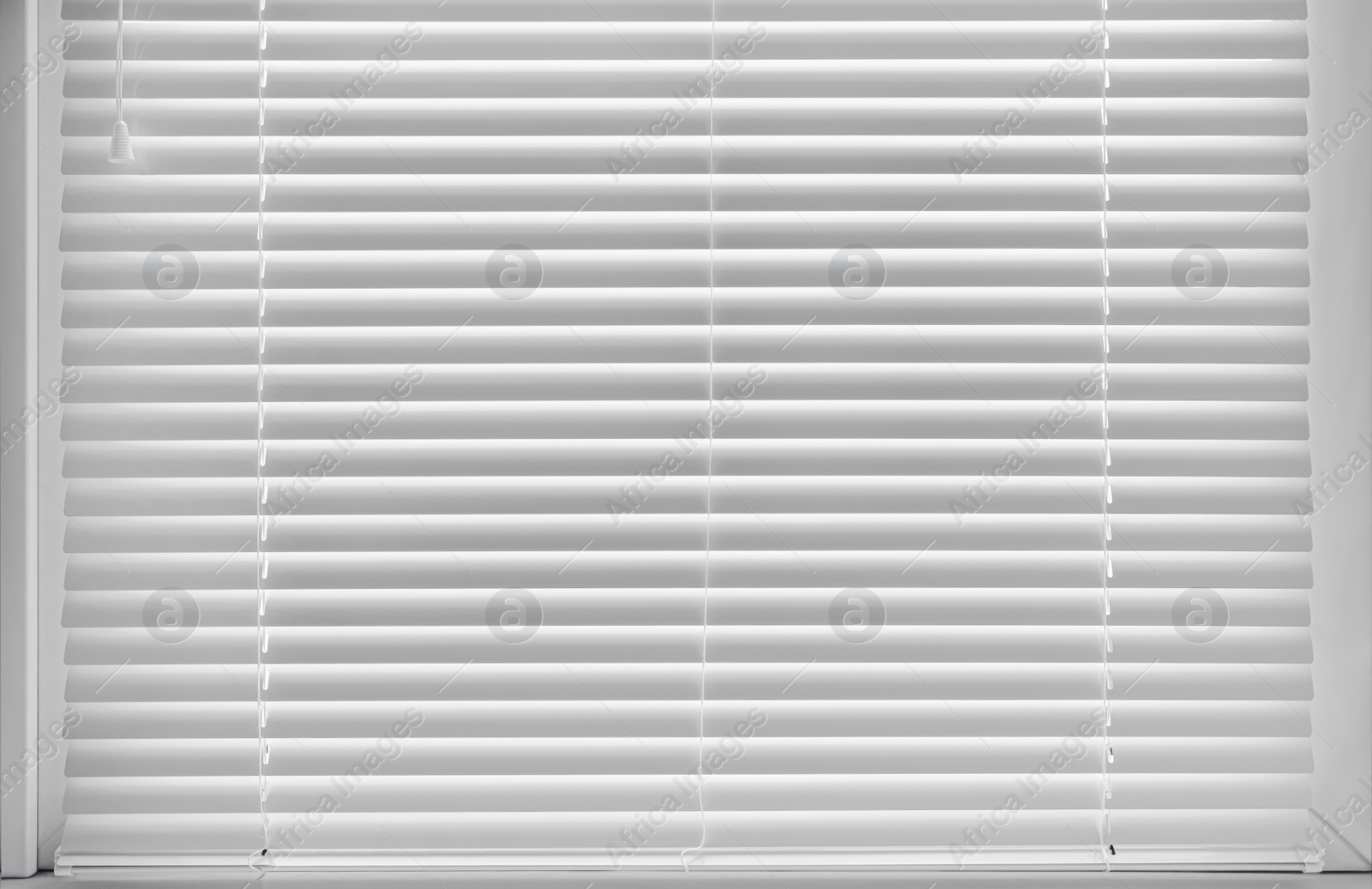 Photo of Stylish window with horizontal blinds in room