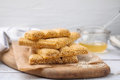 Delicious sesame kozinaki bars on white wooden table, closeup