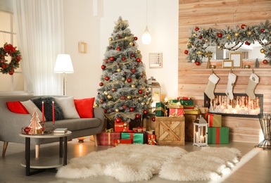 Image of Beautiful Christmas tree in living room. Festive interior