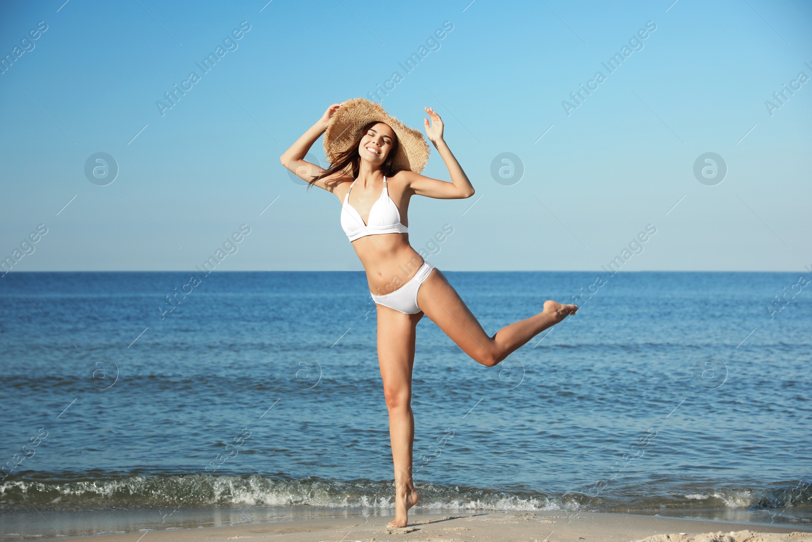 Photo of Beautiful young woman in bikini on beach