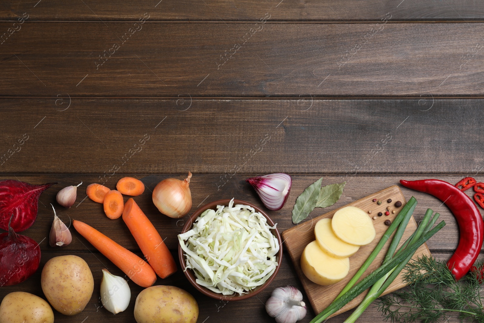 Photo of Fresh borscht ingredients on wooden table, flat lay. Space for text