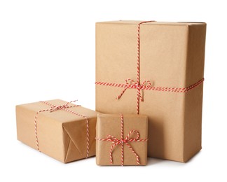 Photo of Gift boxes wrapped in kraft paper with bows on white background