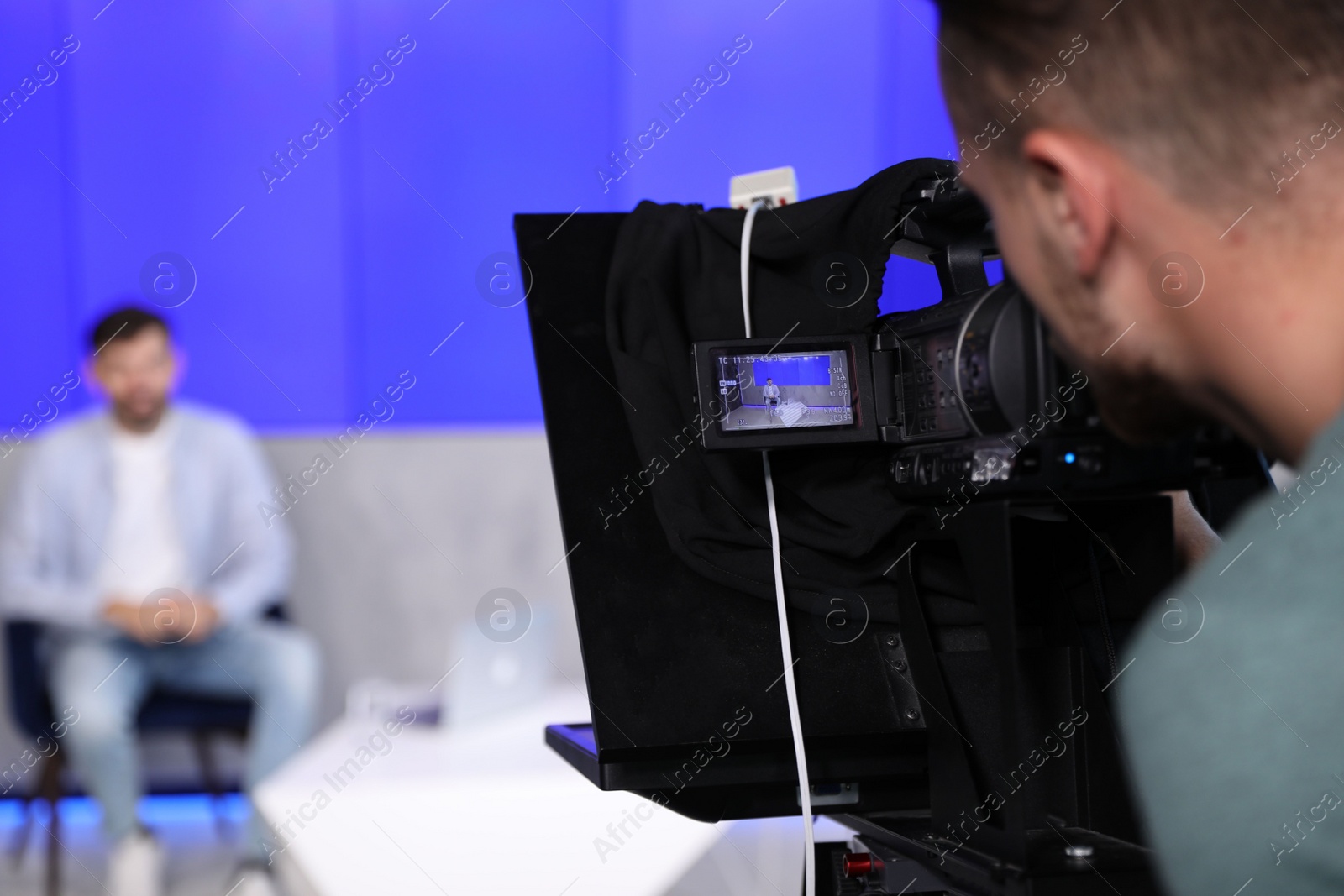 Photo of Professional video camera operator working in studio, closeup