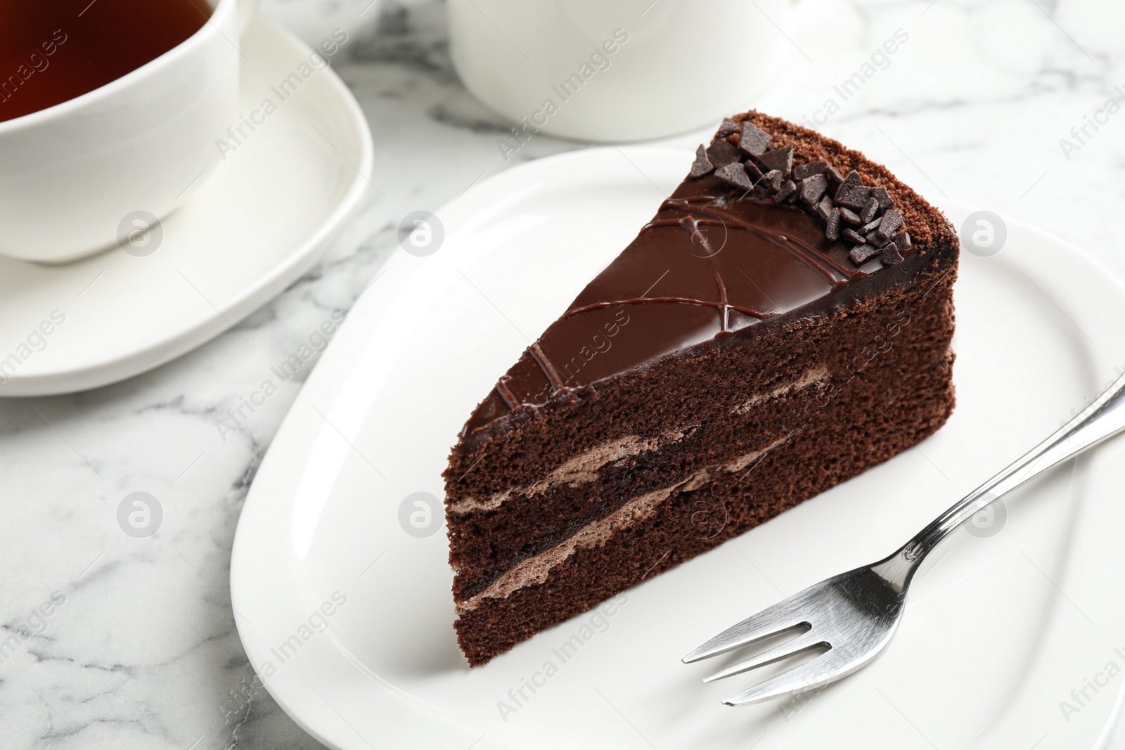 Photo of Piece of tasty chocolate cake served on plate