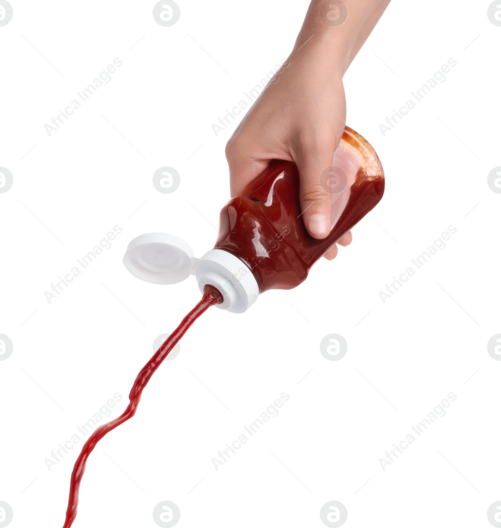 Photo of Woman pouring tasty ketchup from bottle isolated on white, closeup