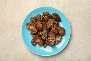 Plate with delicious kidneys and thyme on light table, top view