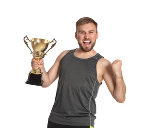 Photo of Portrait of happy young sportsman with gold trophy cup on white background