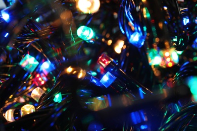 Beautiful glowing Christmas lights, closeup. Festive illumination