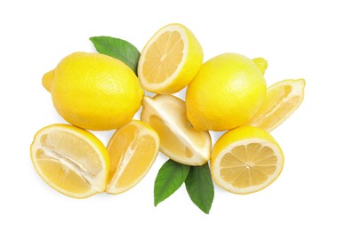 Photo of Cut and whole ripe lemons with green leaves on white background, top view