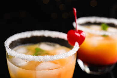 Photo of Fresh alcoholic Tequila Sunrise cocktail on dark background, closeup