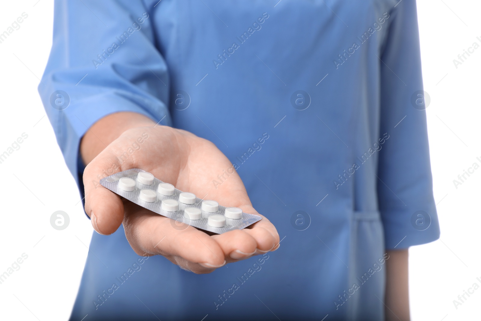 Photo of Female doctor holding pills on white background, closeup. Medical object