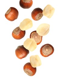 Image of Tasty hazelnuts falling on white background. Healthy snack