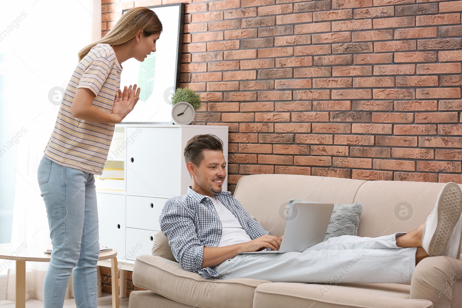 Photo of Lazy husband quarrelling with hardworking wife at home