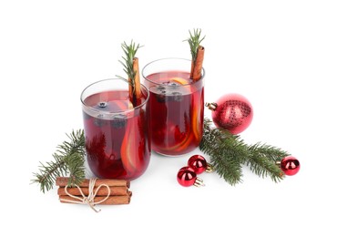 Photo of Aromatic Sangria drink in glasses and Christmas decor on white background