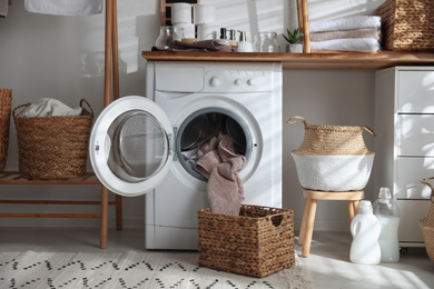 Photo of Stylish bathroom interior with modern washing machine