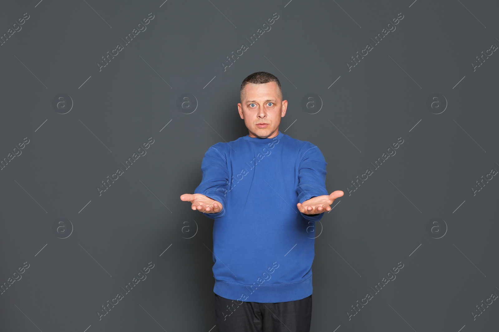 Photo of Portrait of emotional mature man on dark background