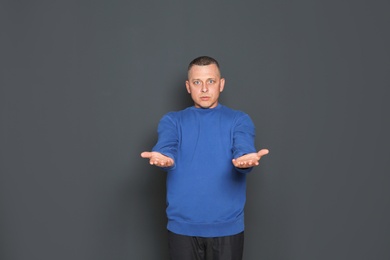 Portrait of emotional mature man on dark background