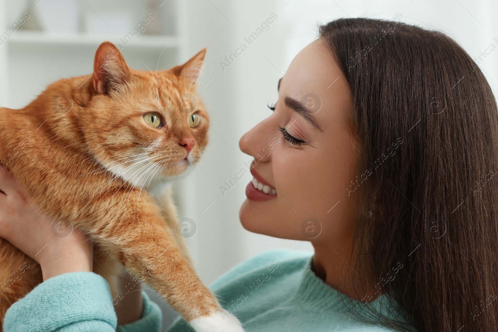 Photo of Beautiful woman with cute cat at home