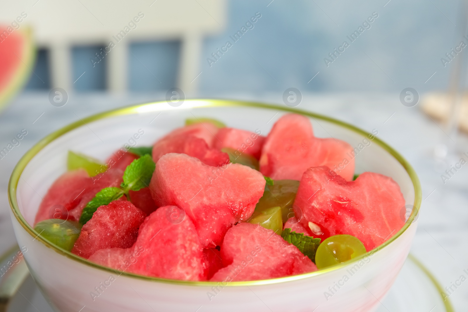 Photo of Delicious salad with watermelon in bowl, closeup