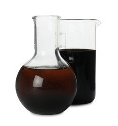 Photo of Beaker and flask with different types of crude oil isolated on white