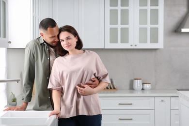 Photo of Dating agency. Happy couple spending time together in kitchen, space for text