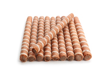 Photo of Delicious chocolate wafer rolls on white background. Sweet food