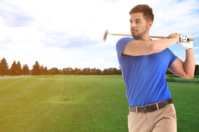 Image of Young man playing golf on course with green grass. Space for design
