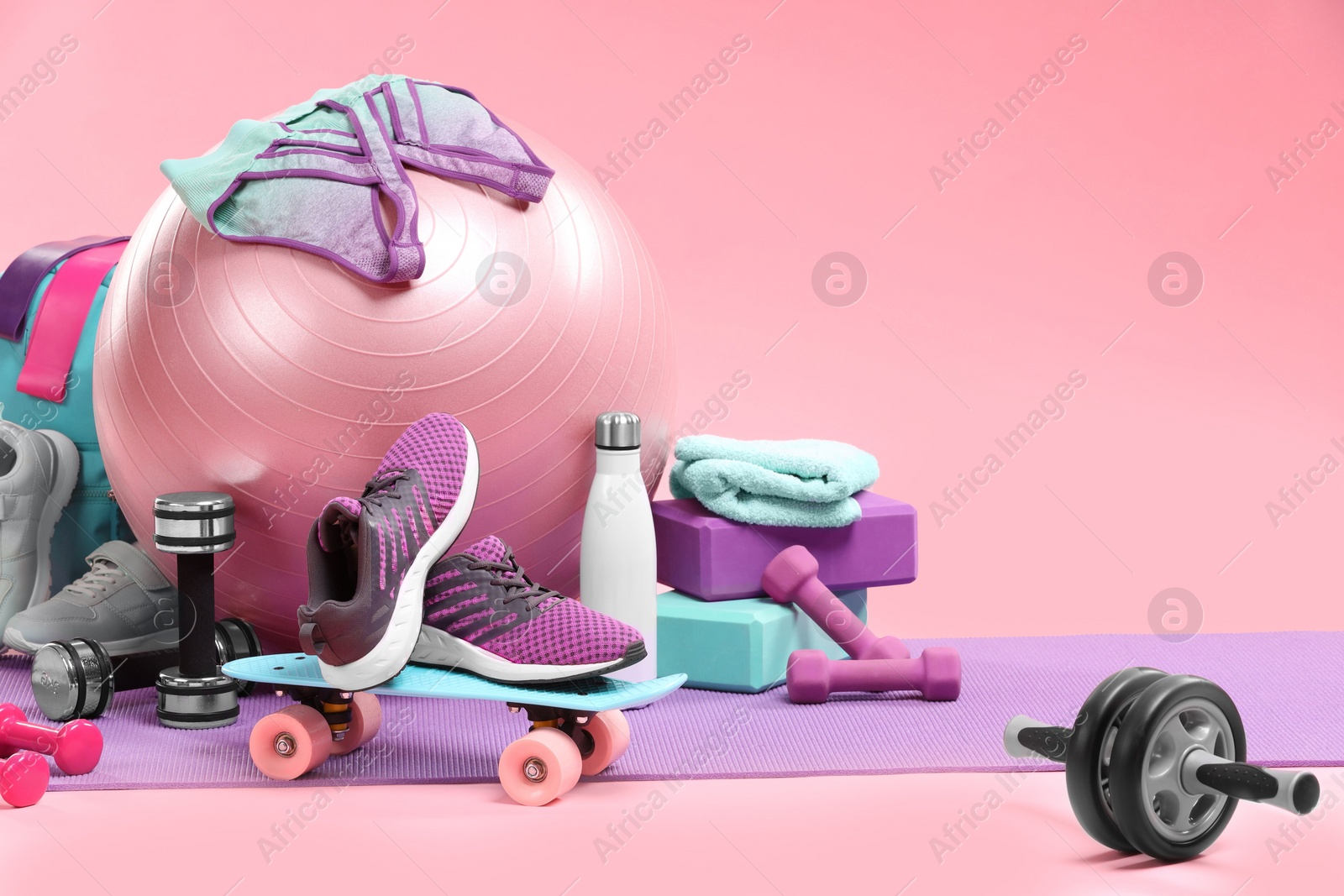 Photo of Many different sports equipment on pink background, space for text