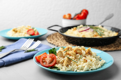 Photo of Delicious chicken risotto served on grey table