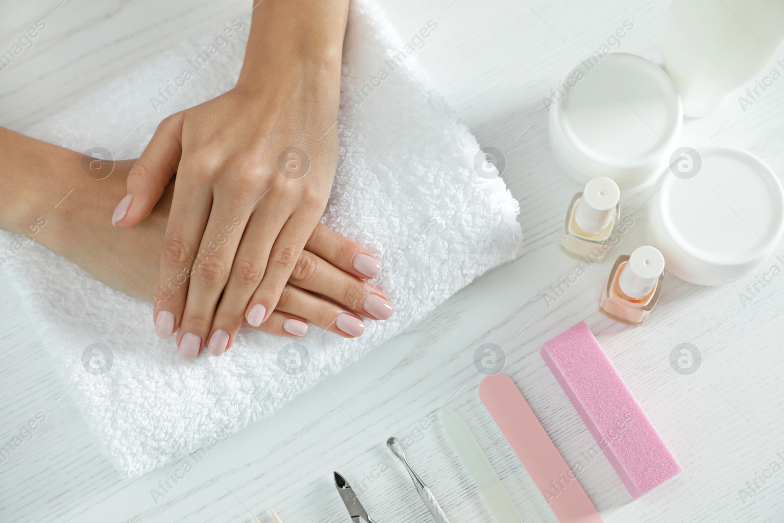 Photo of Woman waiting for manicure and tools at table, top view. Spa treatment